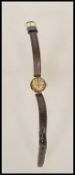 A 9ct gold cased vintage Omega ladies cocktail wrist watch having a metallic dial with gilt baton