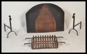 An early to mid 20th Century wrought iron fire grate / basket of rectangular form, raised on a