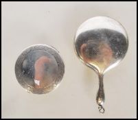 A silver hallmarked miniature ladies compact of round form having engraved geometric borders (