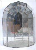 A mid 20th Century glass and lead lined wall hanging terrarium planter of demilune form, having