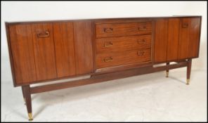 A mid 20th Century teak wood sideboard / credenza, by Ernst Gomme for G-Plan central bank of three