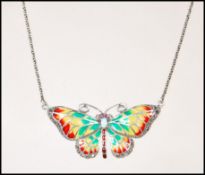 A silver plique a jour opalite Art Nouveau necklace pendant in the form of a butterfly complete with