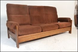 A retro 1960's Danish inspired teak wood day bed sofa. The turned legs supporting a fold down bed