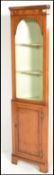 A good quality antique style yew wood corner cabinet raised on bracket feet  with single cupboard