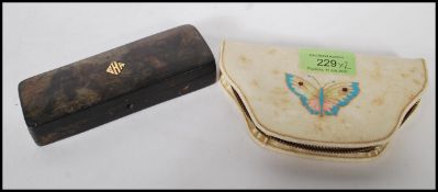 An early 20th Century tortoise shell vanity set having three nail tools within a rectangular