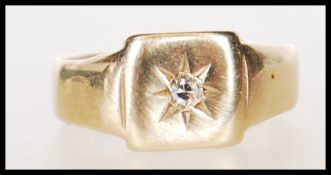 A hallmarked 9ct gold signet ring having a square head set with a brilliant cut diamond.