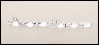 A pair of Art Deco style silver and opalite ladies drop earrings. Each interspersed with CZ oval cut