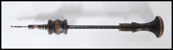 A 19th Century Victorian hand Archimedes drill having a turned wooden handle to the top and spiral