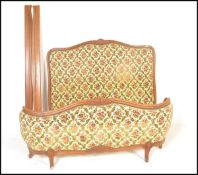 An early 20th century French corbeille bed with chenille upholstered head and footboard united by
