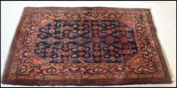 A 19th century Persian / Islamic Keshan rug with red and ble ground having geometric decoration with
