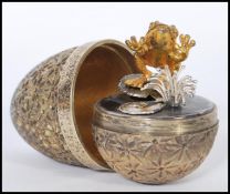 A silver hallmarked Stuart Devlin silver limited edition surprise egg having a stylised floral