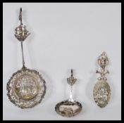 A collection of 3 large Dutch silver spoons to include a large example cast in relief with pierced