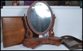 A 19th Century Victorian mahogany swing toilet mirror together with two Edwardian oak twin handled