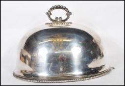 A large 19th century Elkington & Co silver plated domed meat cover with monogram to the upper centre
