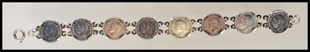 A stamped 925 silver coin bracelet being set with