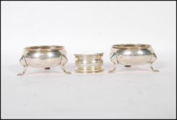 A pair of 18th Century Georgian silver hallmarked table salts of circular form raised on tripod hoof