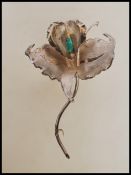 A stamped 900 Colombian silver brooch in the form of an orchid flower being set with a raw