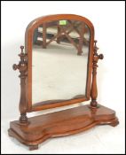 A 19th Century Victorian mahogany dressing table swing mirror of  arch form, raised on shaped base