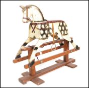 A mid century retro wooden childrens painted rocking horse by Leeway. Complete with the original