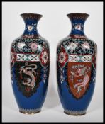 A pair of Japanese cloisonne vases of rounded square form having waisted flared rims, having