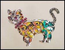 A contemporary silver plique a jour ladies brooch in the form of a cat with curly tail. Measures