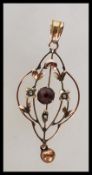 A 19th Century Victorian marked 9ct gold open work pendant set with seed pearls and a central