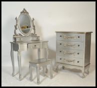 A contemporary French silvered commode chest of drawers with matching dressing table and stool. Each