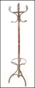 A Thonet style 20th century bentwood hat stand with shaped base and hoop stick stand having hooks