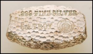 A solid 999 purity silver nugget marked 'Tombstone Arizona Territory Silver Nugget' made by the