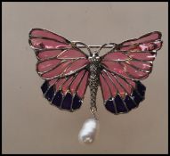 A silver stamped 925 plique a jour brooch in the form of a butterfly, 110the wings with pink and