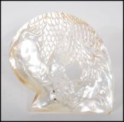 A 20th Century Indian carved shell ornament depicting a lion hunting a deer beneath a tree having