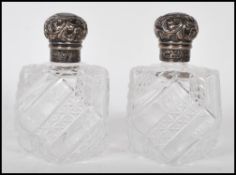 A pair of 19th Century Victorian silver hallmarked topped cut glass perfume bottles of octagonal