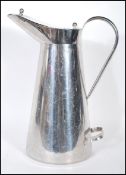A 20th Century industrial farmers milk jug / churn having a chromed finish, lidded top and pouring
