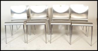 A set of eight panel stacking dining  chairs, the chairs panels having a silvered finish raised on