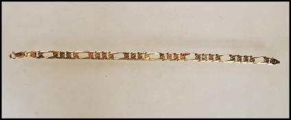 A stamped 9ct gold flat link bracelet having a lobster clasp. Measures 9 inches. Weight 17.1g.