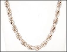 A 20th Century Chinese silver necklace having a rope twist chain terminating in dragons heads with a