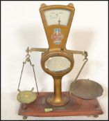 A set of vintage 20th Century shop grocery balance scales, gilt body with glazed dial to the top,