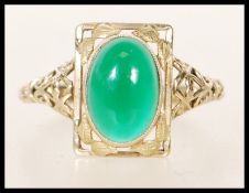 A stamped 9ct gold ladies ring having pierced foliate decoration to the shank and head being set