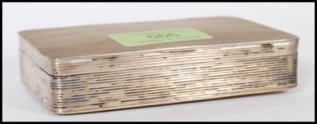 A early 20th Century 1920's sewing kit having a reeded silver white metal case having a fitted