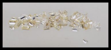 A group of loose rectangular cut diamonds of varying sizes totalling 3.89ct's.