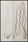 A selection of stamped 925 silver necklaces to include a snake chain necklace with a crucifix