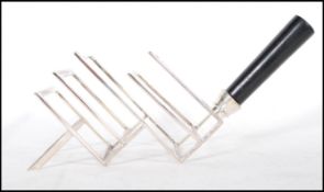 A Christopher Dresser manner toast rack being of silver plated construction with ebonised turned