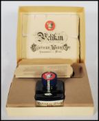 A West German Gunther Wagner Pelikan fountain pen in a black colourway with gilt details, in its