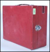 An early 20th Century vintage HMV wind-up picnic gramophone in a red carry case, metal fittings