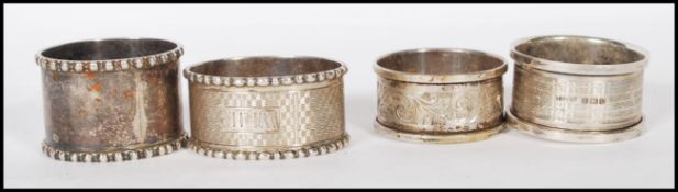 A group of four silver hallmarked napkin rings to include a scrolled acanthus leaf design ring (
