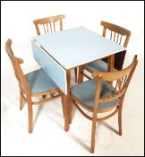 A retro mid 20th Century 1950's pale blue Formica topped drop leaf kitchen dining table raised on