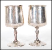 A pair of silver hallmarked Cooper Brothers & Sons goblets having round bases with bark effect