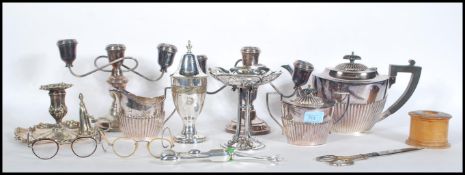 A pair of silver hallmarked sugar tongs together with a collection of silver plated items to include