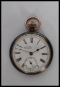 A early 20th century white metal open face pocket watch, having white enamel face with roman