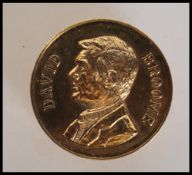 A gilded silver hallmarked medal coin cast in relief with notation for David Broome World Show